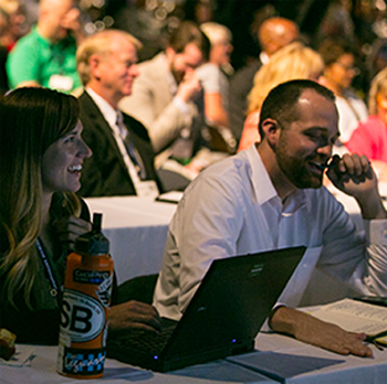 attendees at a table with laptop